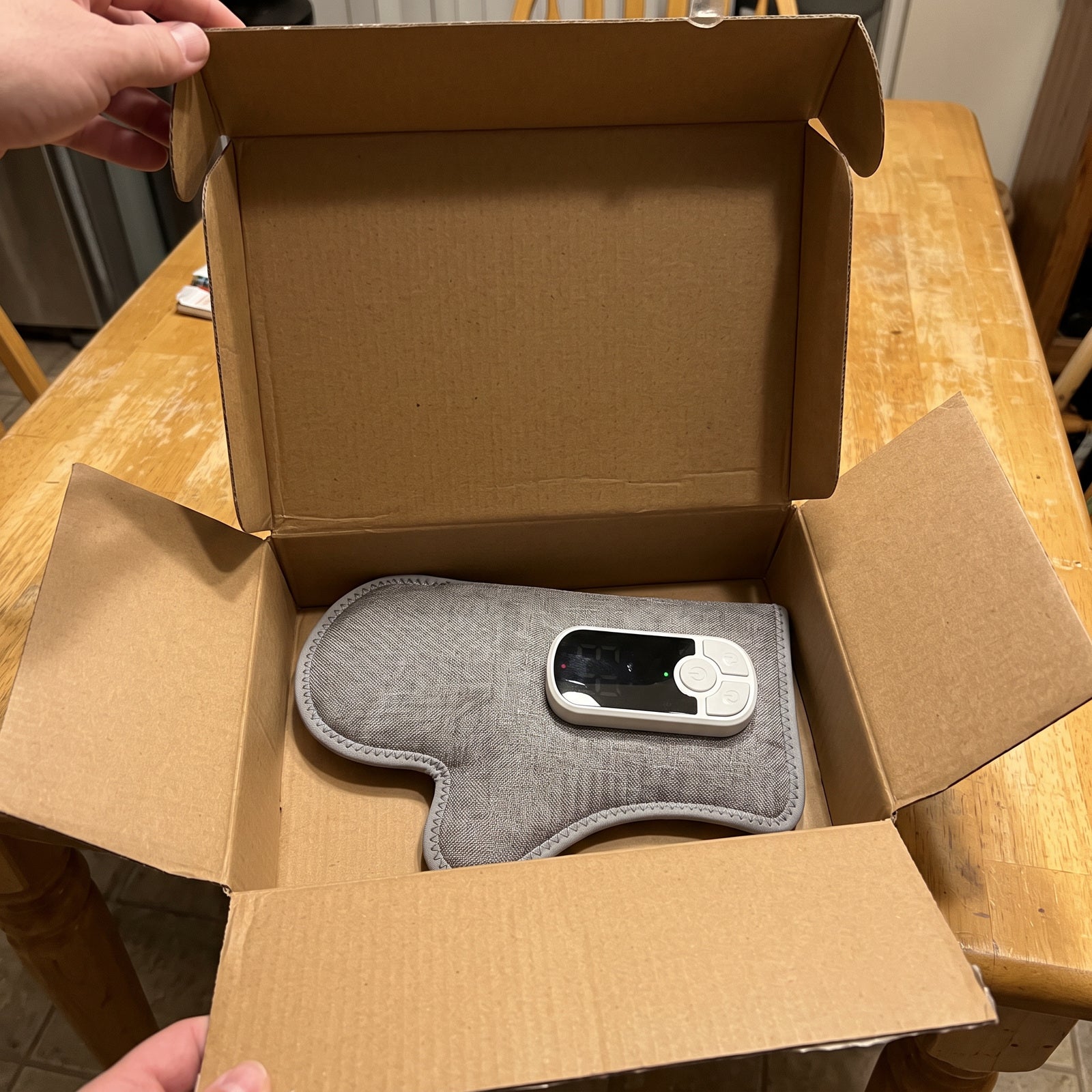 Unpacking Palmhaven from a plain cardboard box on a kitchen table
